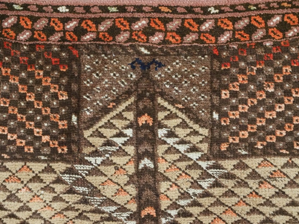 An antique hand-knotted Turkmen wool prayer rug featuring a dark brown and terracotta diamond lattice pattern with a prayer arch at the top. View VIII