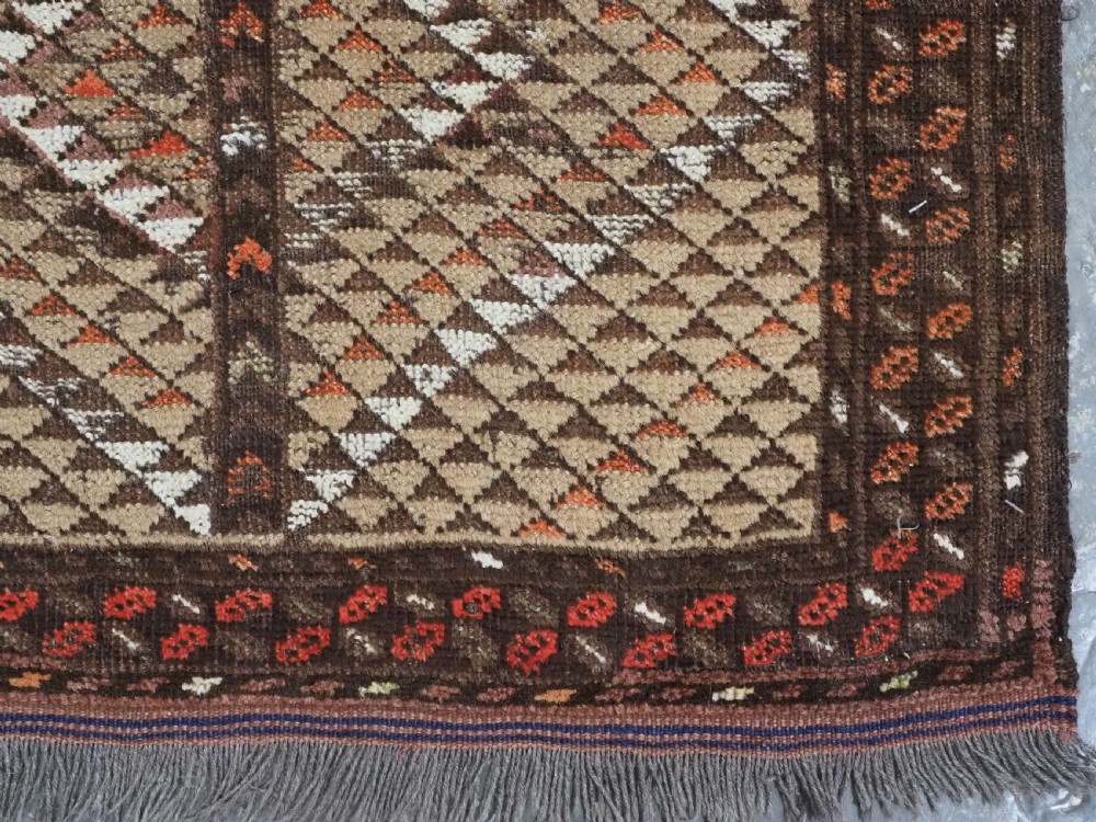 An antique hand-knotted Turkmen wool prayer rug featuring a dark brown and terracotta diamond lattice pattern with a prayer arch at the top. View XII