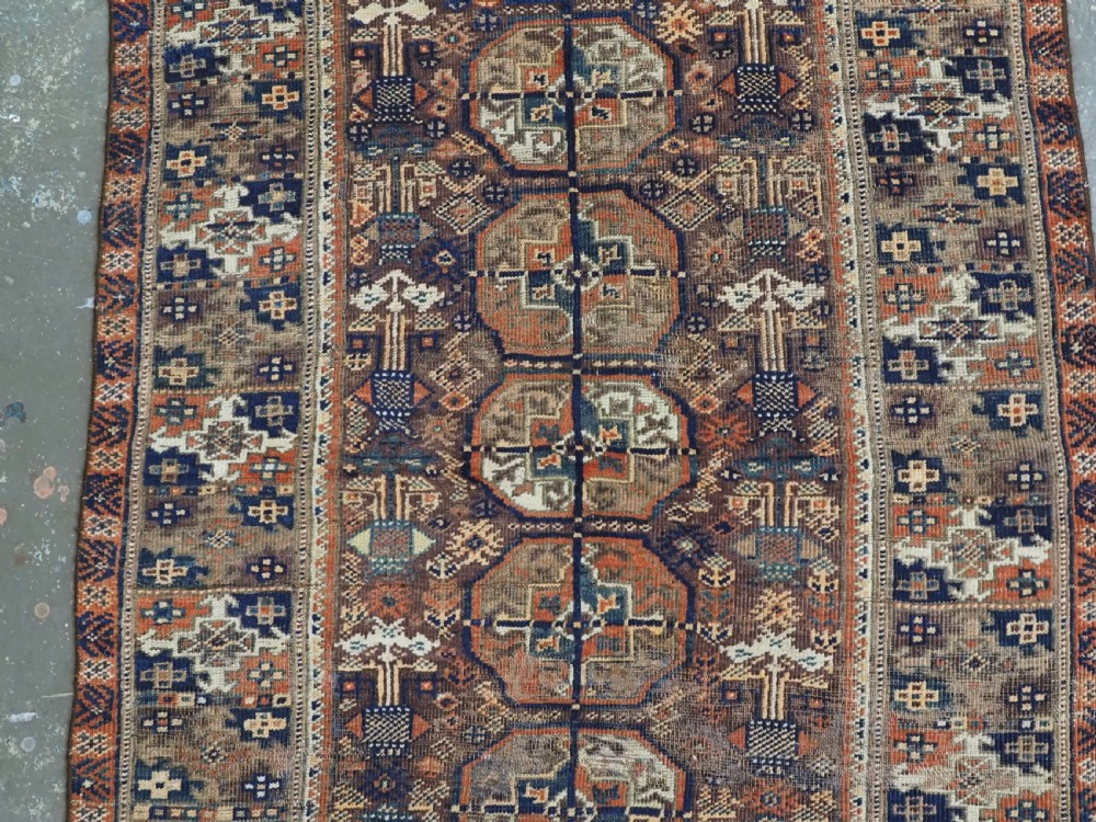 ANTIQUE MAHDAD KHANI BALUCH RUG OF INTERESTING TURKMEN GUL DESIGN, CIRCA 1880. View IV