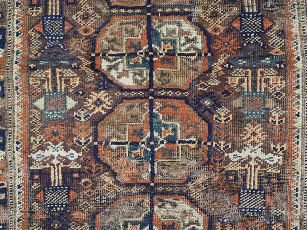 ANTIQUE MAHDAD KHANI BALUCH RUG OF INTERESTING TURKMEN GUL DESIGN, CIRCA 1880. View IX
