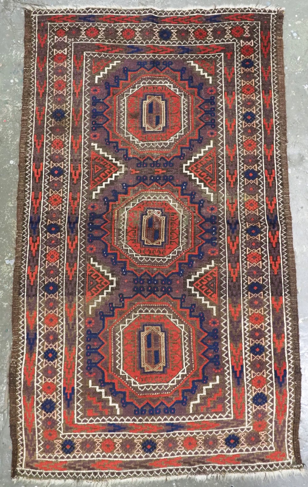 ANTIQUE KHORASAN BALUCH RUG, POSSIBLY SALAR KHANI WITH LARGE GULS, CIRCA 1900.