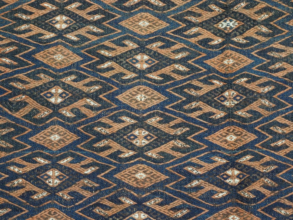 An antique Yomut Turkmen Soumak flatweave rug featuring an all-over geometric diamond lattice pattern in dark brown, terracotta, and navy blue. View VIII