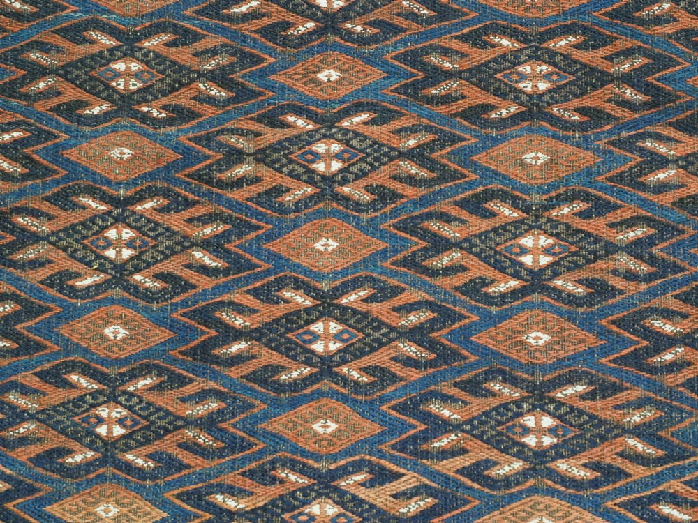 An antique Yomut Turkmen Soumak flatweave rug featuring an all-over geometric diamond lattice pattern in dark brown, terracotta, and navy blue. View IX