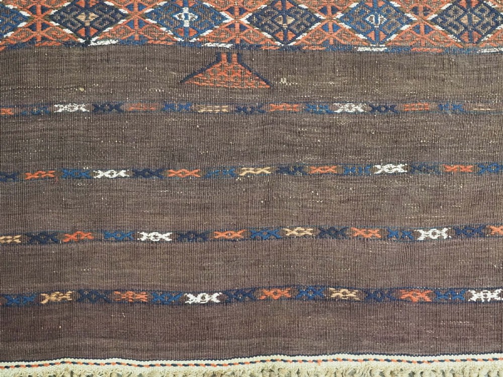 An antique Yomut Turkmen Soumak flatweave rug featuring an all-over geometric diamond lattice pattern in dark brown, terracotta, and navy blue. View XI