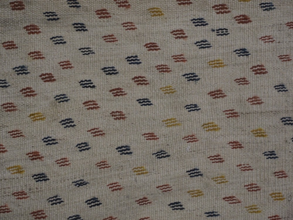 A flatwoven wool kilim rug featuring horizontal bands of cream, dark brown, and ochre with geometric diamond patterns. View IX