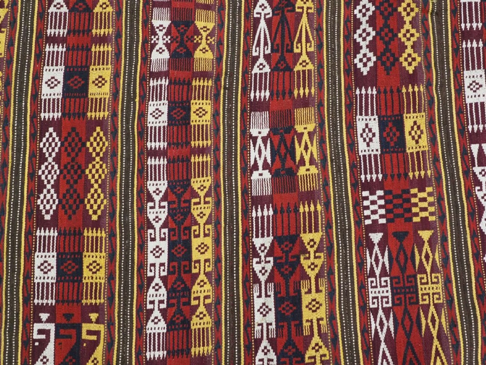 An antique handwoven Uzbek Gajeri wool kilim rug featuring vertical bands of geometric motifs in red, yellow, black, and cream shades. View VII