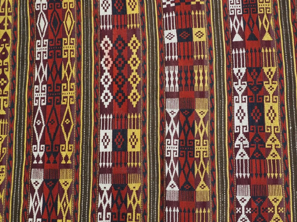 An antique handwoven Uzbek Gajeri wool kilim rug featuring vertical bands of geometric motifs in red, yellow, black, and cream shades. View VIII