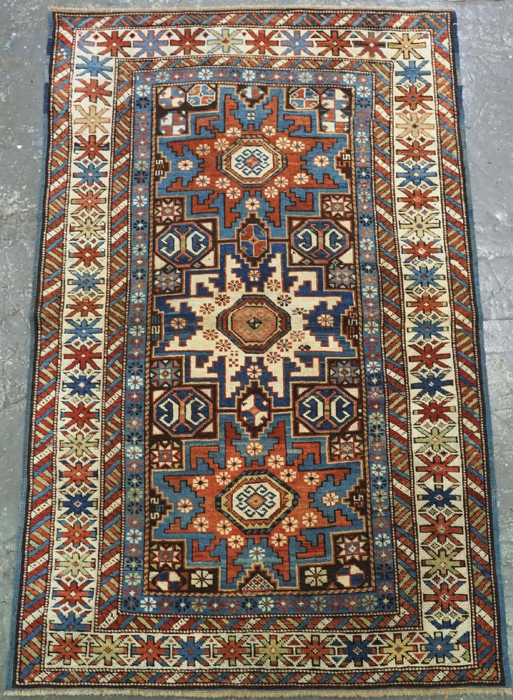 ANTIQUE CAUCASIAN RUG WITH LESGHI STAR DESIGN, EXCELLENT COLOUR, CIRCA 1890.