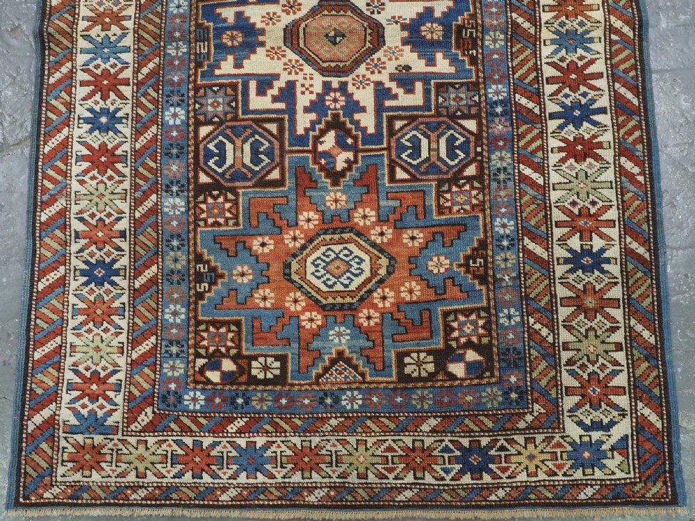 ANTIQUE CAUCASIAN RUG WITH LESGHI STAR DESIGN, EXCELLENT COLOUR, CIRCA 1890. View V