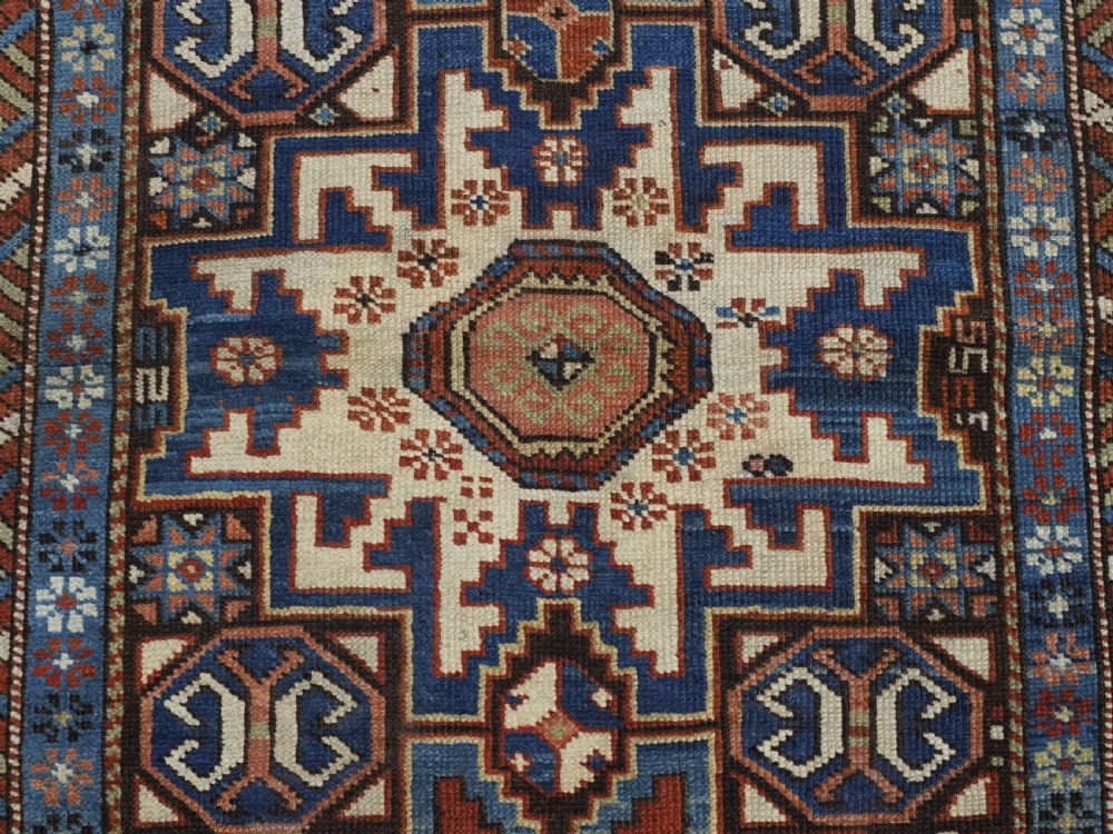 ANTIQUE CAUCASIAN RUG WITH LESGHI STAR DESIGN, EXCELLENT COLOUR, CIRCA 1890. View X