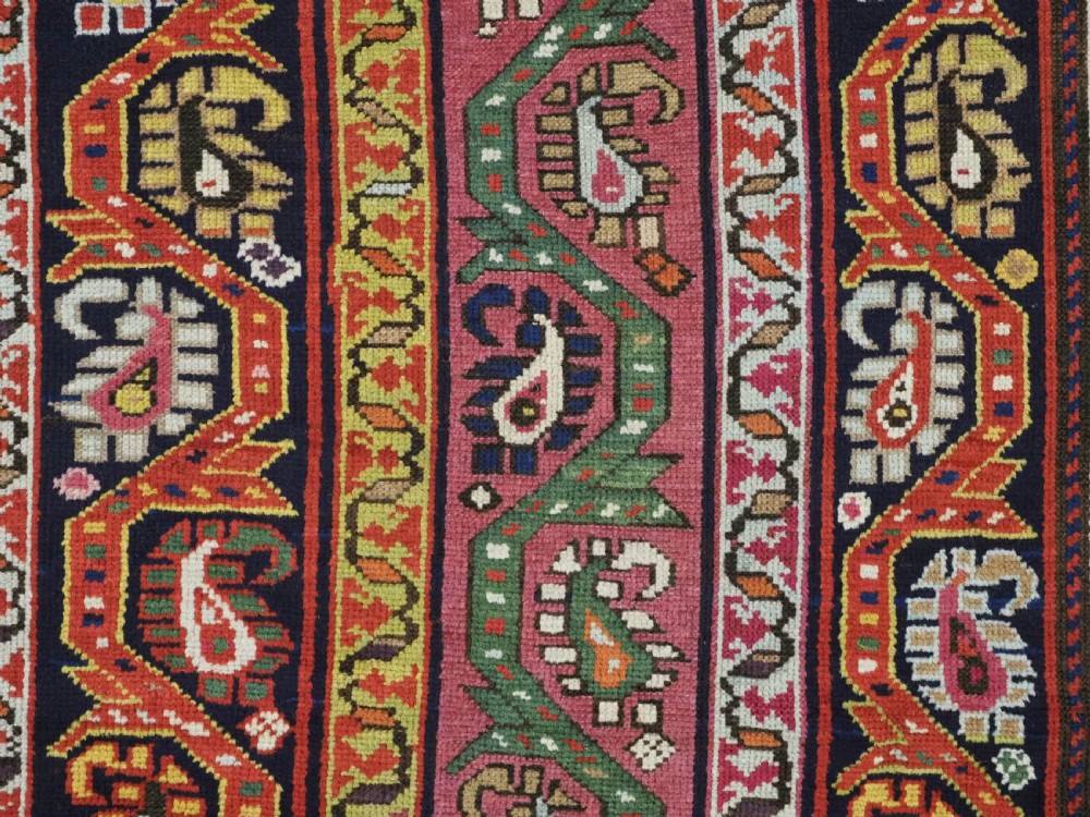 An antique Caucasian Karabagh runner rug featuring vertical polychrome stripes filled with repeating boteh motifs framed by multiple floral borders. View VIII
