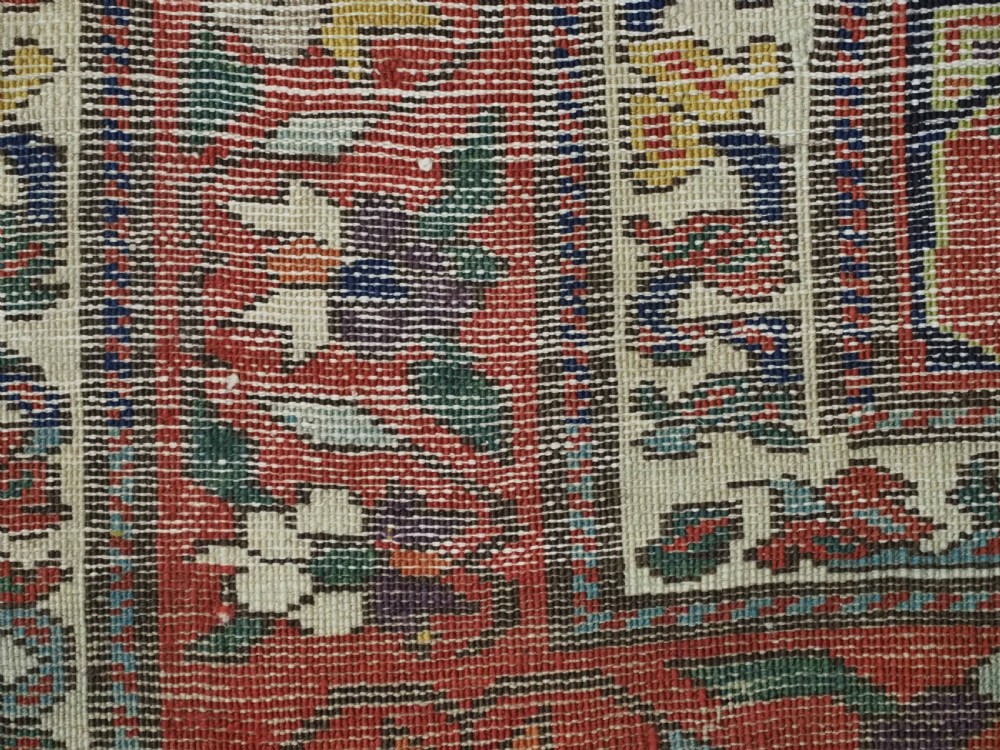 An antique Caucasian Karabagh runner rug featuring vertical polychrome stripes filled with repeating boteh motifs framed by multiple floral borders. View XI