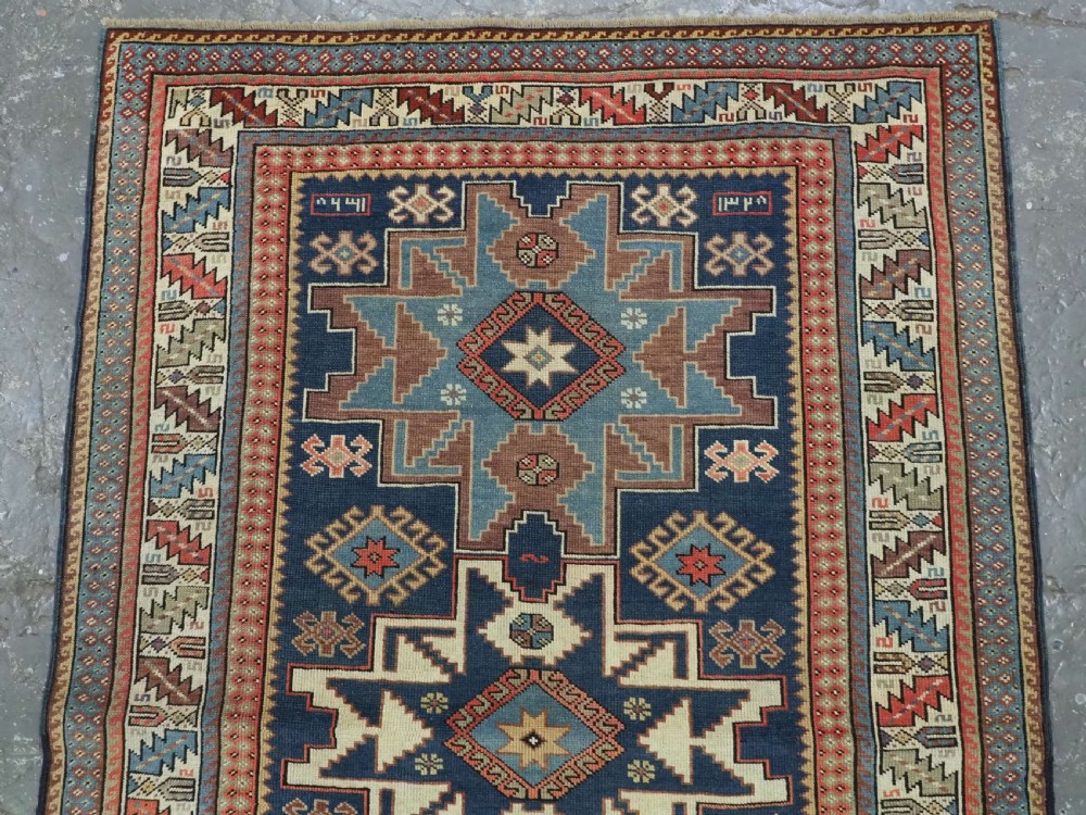 ANTIQUE CAUCASIAN LESGHI STAR DESIGN RUG, DATED 1328 / 1910. View III