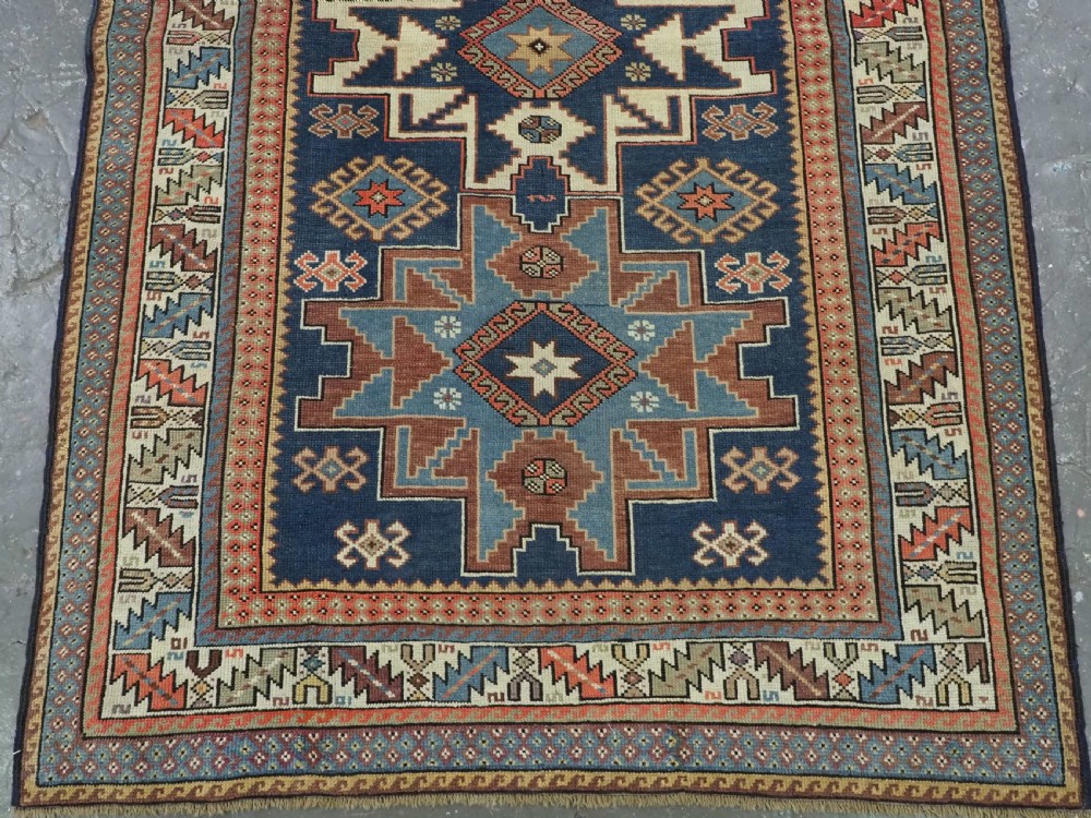 ANTIQUE CAUCASIAN LESGHI STAR DESIGN RUG, DATED 1328 / 1910. View V