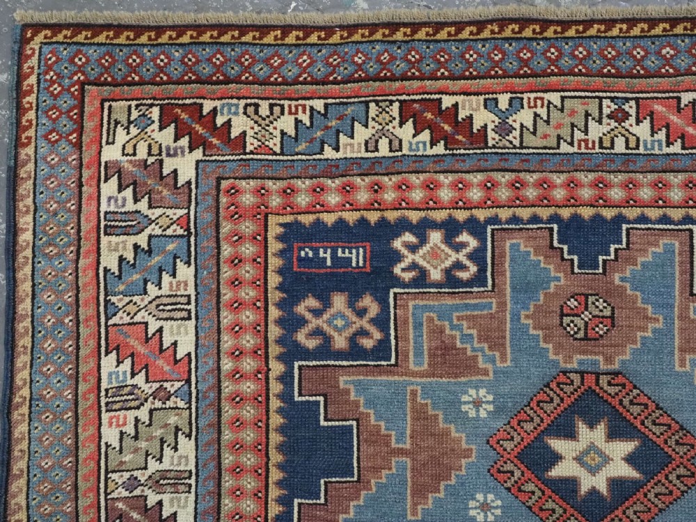 ANTIQUE CAUCASIAN LESGHI STAR DESIGN RUG, DATED 1328 / 1910. View VI