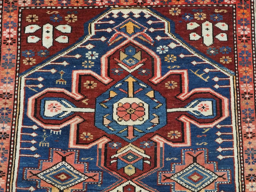 A hand-knotted antique Caucasian rug featuring three lobed medallions on a navy blue field surrounded by intricate geometric borders. View VIII