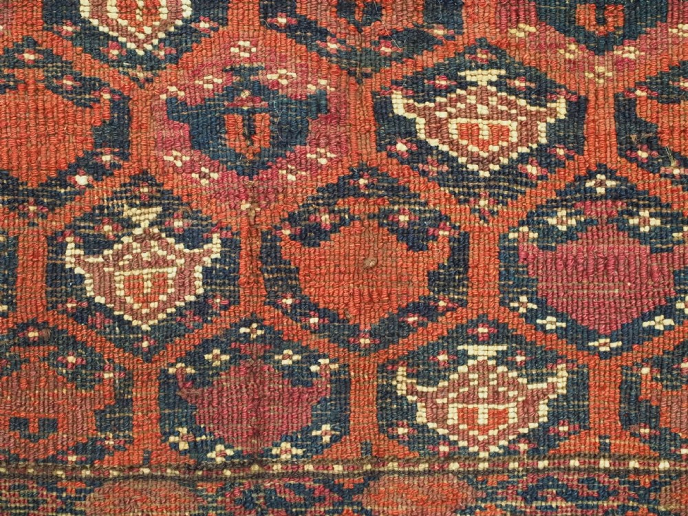 A horizontal rectangular hand-knotted Turkmen torba with repeating red and blue Shemle guls and long wool fringe along the lower border. View XI
