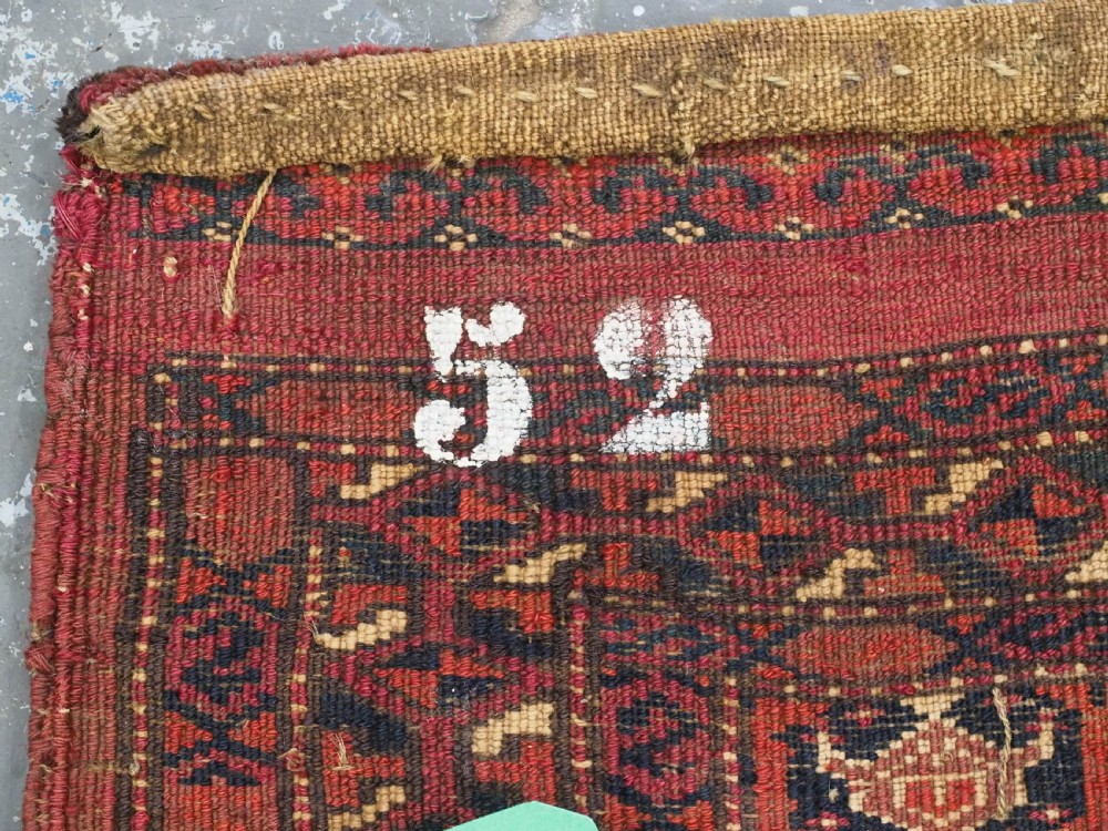 A horizontal rectangular hand-knotted Turkmen torba with repeating red and blue Shemle guls and long wool fringe along the lower border. View XII