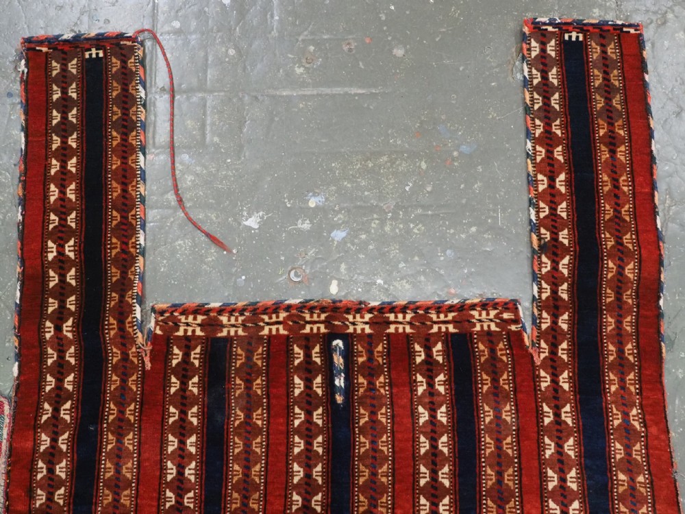 An antique Yomut Turkmen handwoven wool horse cover with vertical geometric stripes in dark blue, ivory, and terracotta red, edged with fringe trim. View III