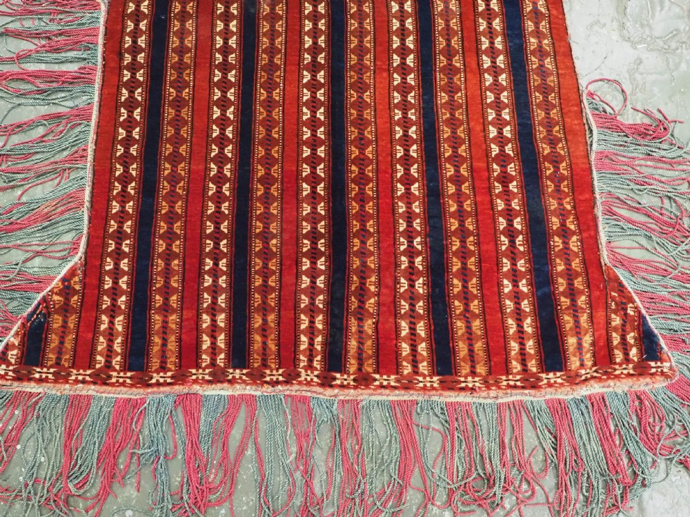 An antique Yomut Turkmen handwoven wool horse cover with vertical geometric stripes in dark blue, ivory, and terracotta red, edged with fringe trim. View V