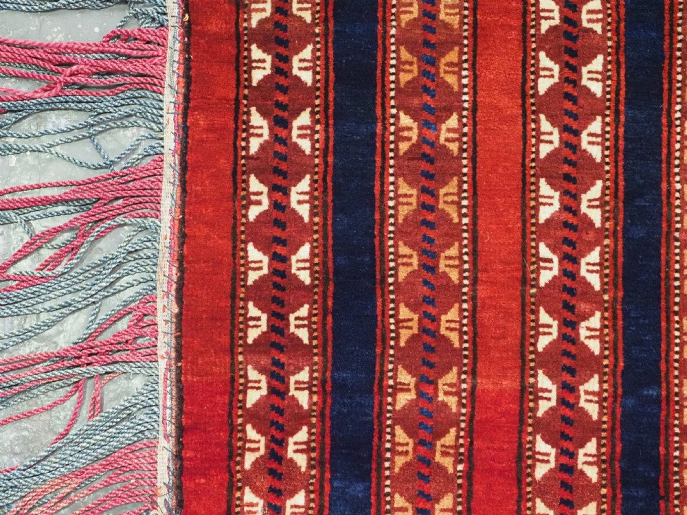 An antique Yomut Turkmen handwoven wool horse cover with vertical geometric stripes in dark blue, ivory, and terracotta red, edged with fringe trim. View VII