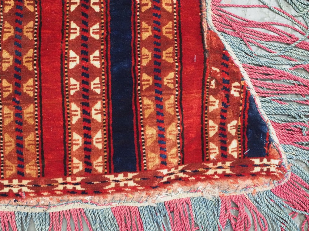 An antique Yomut Turkmen handwoven wool horse cover with vertical geometric stripes in dark blue, ivory, and terracotta red, edged with fringe trim. View X