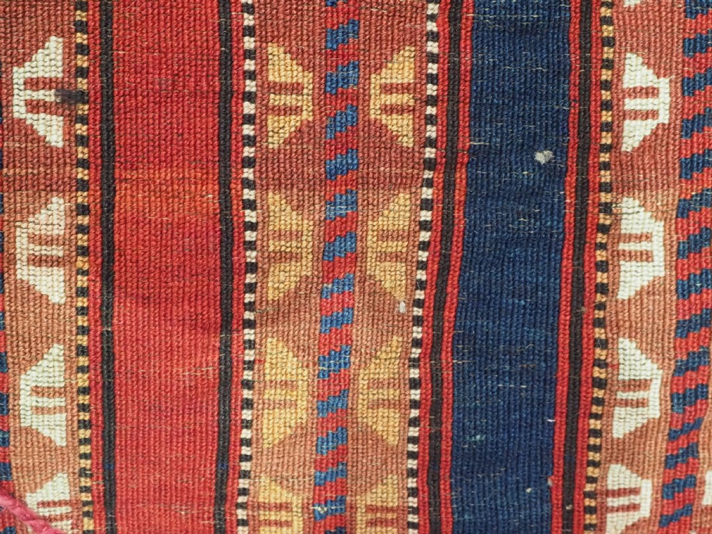 An antique Yomut Turkmen handwoven wool horse cover with vertical geometric stripes in dark blue, ivory, and terracotta red, edged with fringe trim. View XII