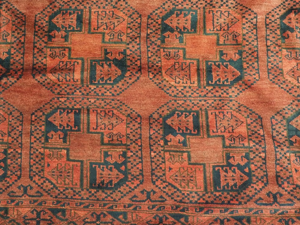 A large antique Afghan Ersari hand-knotted wool carpet featuring repeating octagonal gul motifs across a deep red field framed by geometric borders. View XI