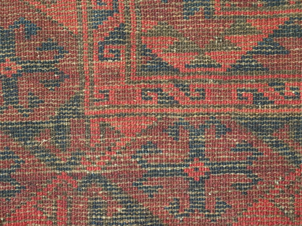 A large antique Afghan Ersari hand-knotted wool carpet featuring repeating octagonal gul motifs across a deep red field framed by geometric borders. View XIII