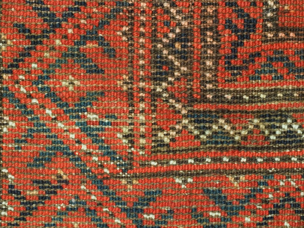An elongated antique Turkmen Kizil Ayak wool carpet featuring multiple rectangular compartments filled with octagonal geometric guls in deep red, navy blue, and ivory tones. View XVI