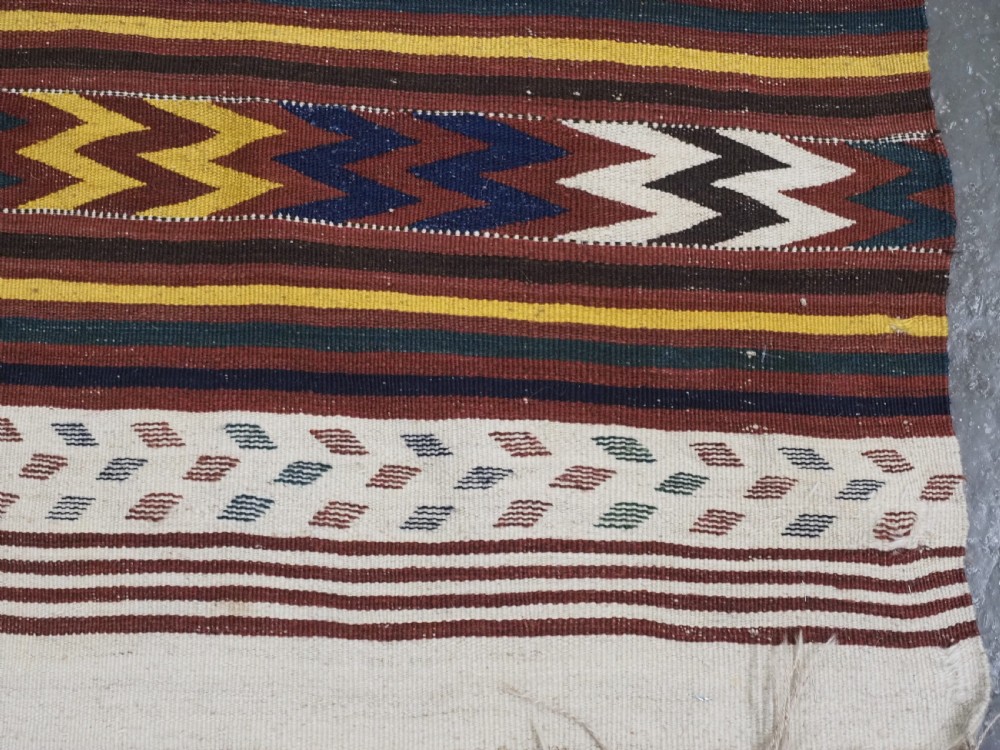 A long handwoven flatweave Central Asian kilim runner displaying cream sections alternating with dark brown, yellow, and red geometric bands with fringe at both ends. View XIII
