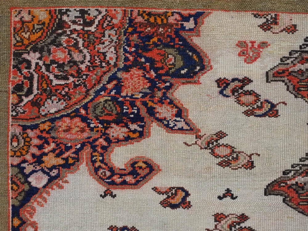 An antique Persian Malayer hand-knotted wool rug featuring an ivory central field, a complex terracotta and navy medallion, butterfly motifs, and a detailed multi-stripe border. View VIII