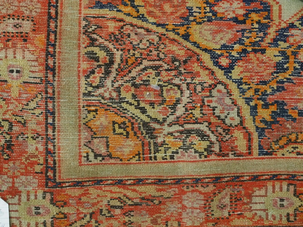 An antique Persian Malayer hand-knotted wool rug featuring an ivory central field, a complex terracotta and navy medallion, butterfly motifs, and a detailed multi-stripe border. View XV