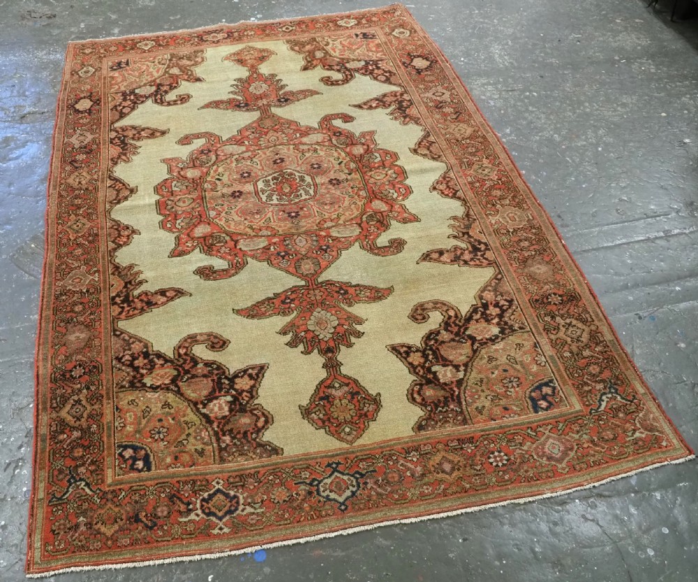 An antique hand-knotted Persian Malayer rug featuring a central terracotta medallion on a cream field with geometric patterned borders. View II