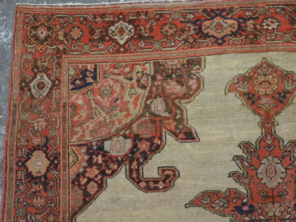 An antique hand-knotted Persian Malayer rug featuring a central terracotta medallion on a cream field with geometric patterned borders. View VI