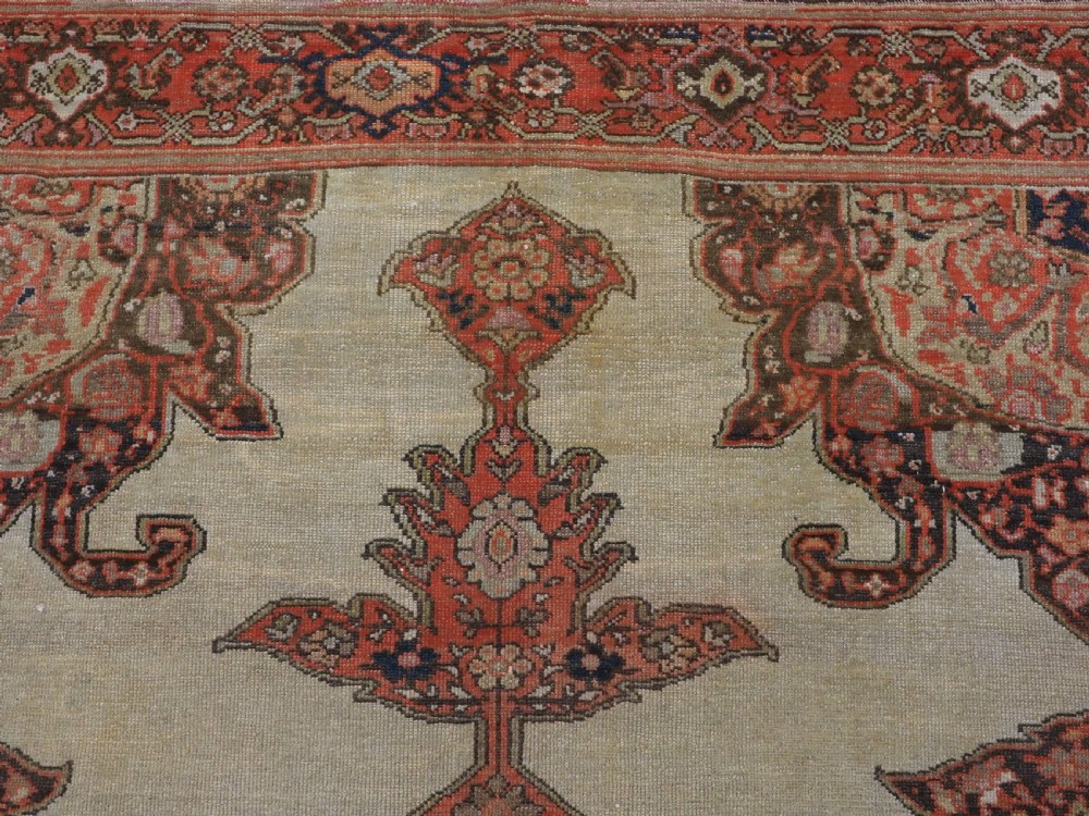 An antique hand-knotted Persian Malayer rug featuring a central terracotta medallion on a cream field with geometric patterned borders. View VIII