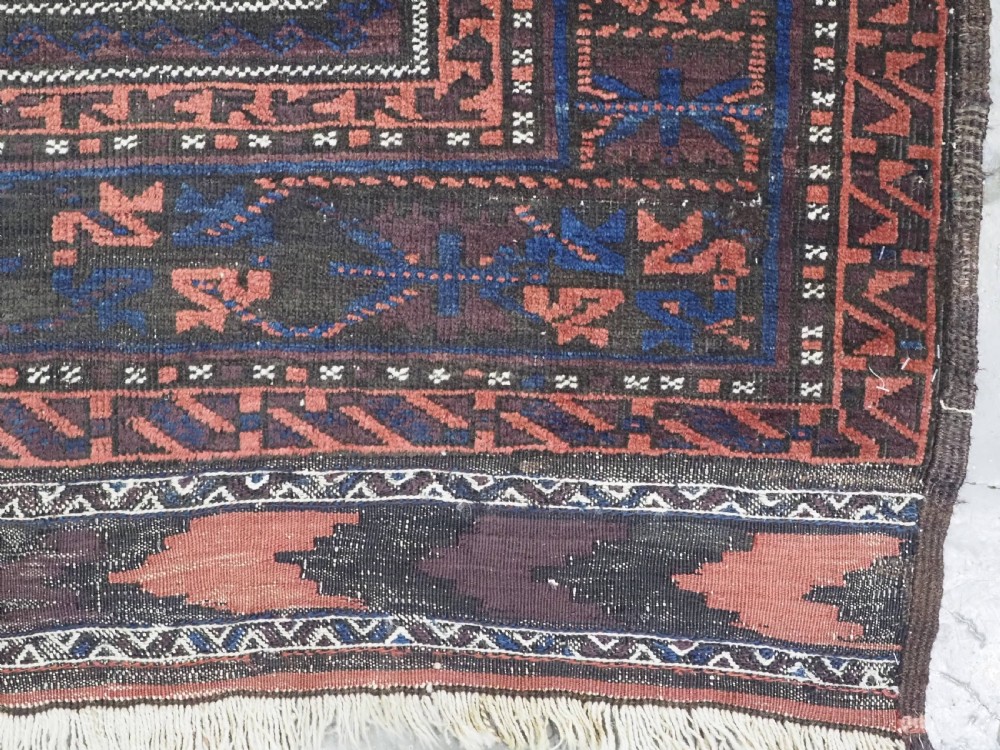 A rectangular antique hand-knotted wool carpet featuring deep indigo blue and madder red geometric motifs with geometric borders and white star details. View XIII