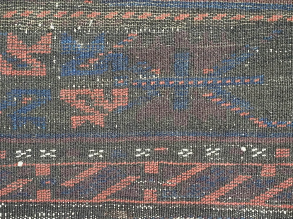 A rectangular antique hand-knotted wool carpet featuring deep indigo blue and madder red geometric motifs with geometric borders and white star details. View XIV