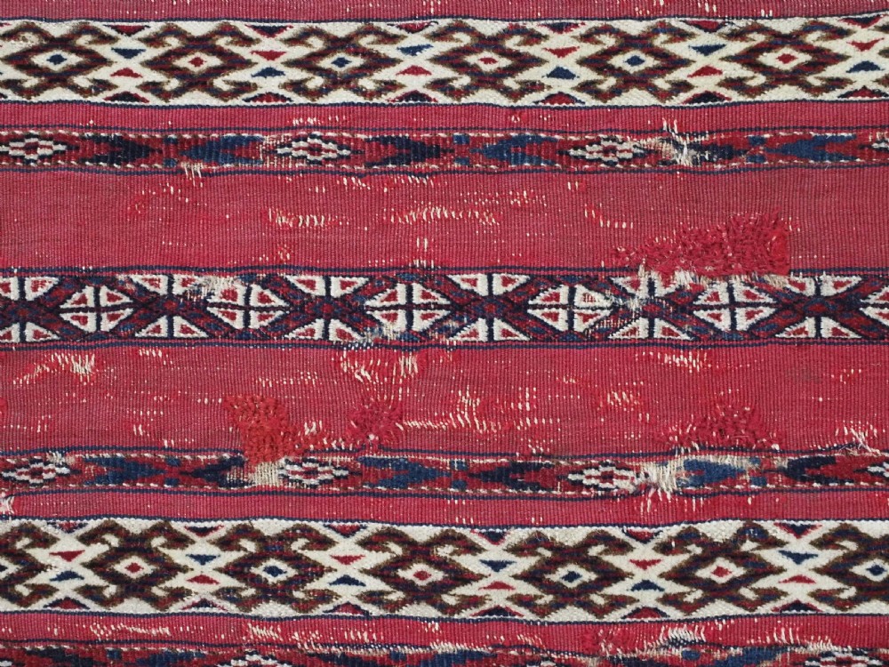 An antique Tekke Turkmen Ak chuval face displaying red and dark blue horizontal bands above a patterned ivory geometric lower panel. View VIII