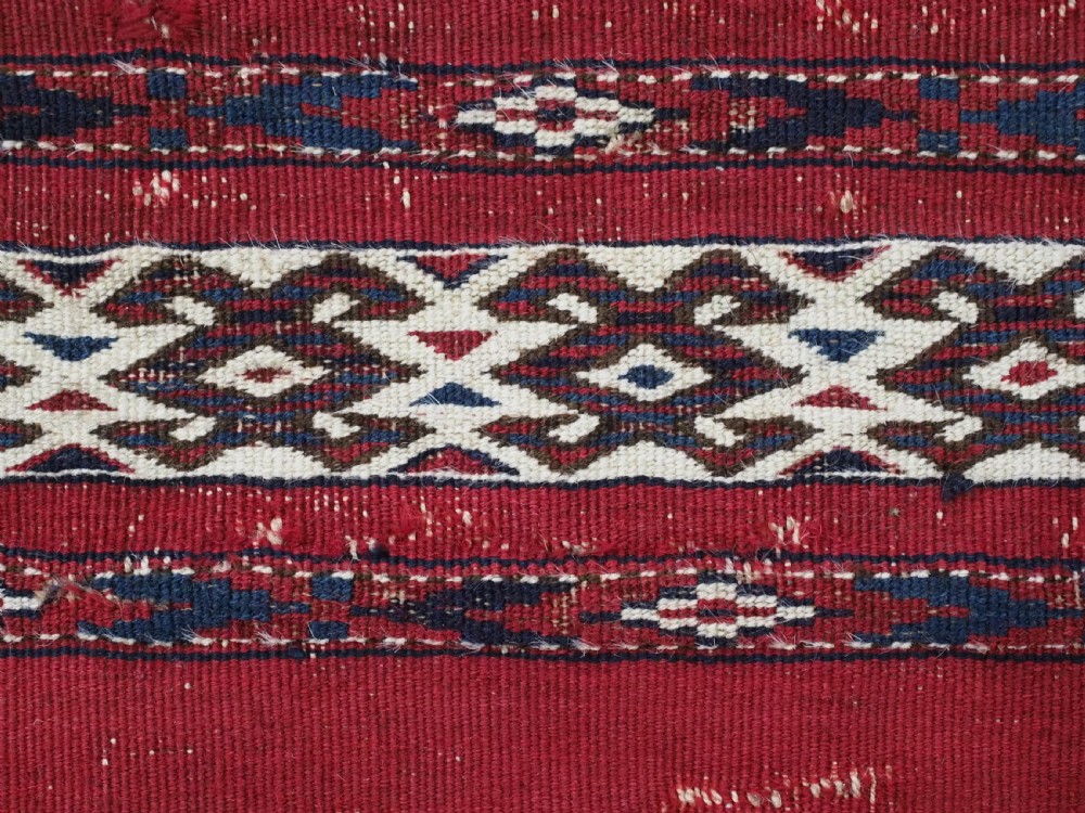 An antique Tekke Turkmen Ak chuval face displaying red and dark blue horizontal bands above a patterned ivory geometric lower panel. View XIII
