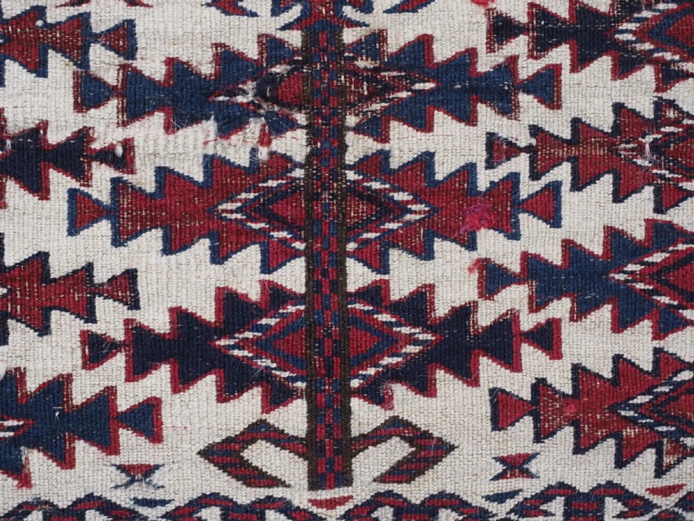 An antique Tekke Turkmen Ak chuval face displaying red and dark blue horizontal bands above a patterned ivory geometric lower panel. View XIV