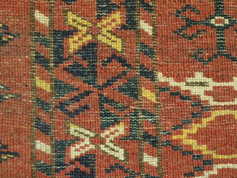 A horizontal antique hand-knotted Turkmen wool torba featuring rust red, black, and cream geometric ikat motifs. View XII