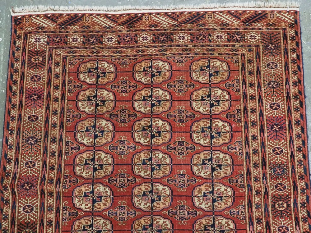 ANTIQUE TEKKE TURKMEN RUG WITH SOFT MADDER RED GROUND, CIRCA 1900. View III