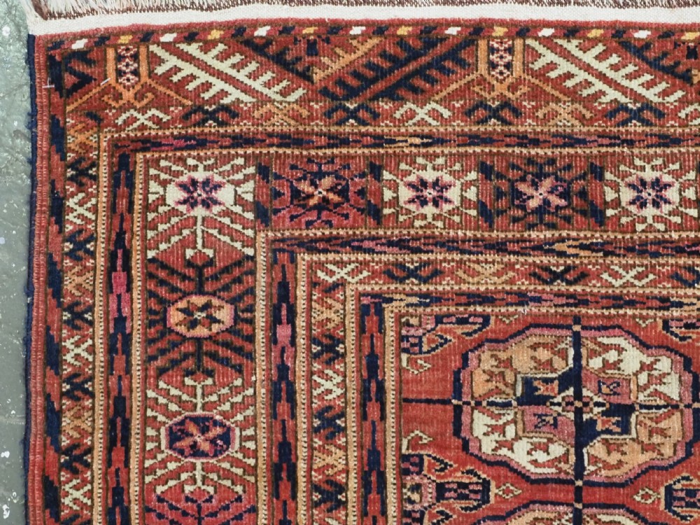 ANTIQUE TEKKE TURKMEN RUG WITH SOFT MADDER RED GROUND, CIRCA 1900. View IV
