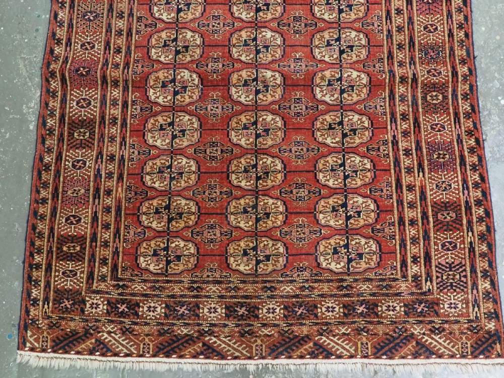 ANTIQUE TEKKE TURKMEN RUG WITH SOFT MADDER RED GROUND, CIRCA 1900. View V