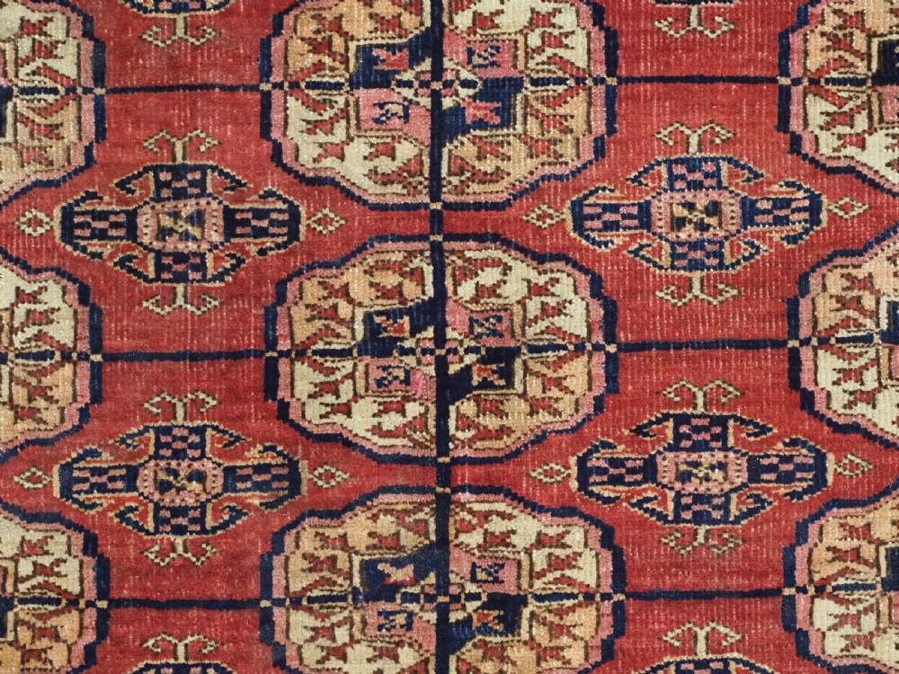 ANTIQUE TEKKE TURKMEN RUG WITH SOFT MADDER RED GROUND, CIRCA 1900. View VIII