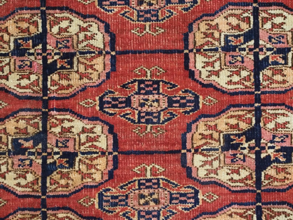 ANTIQUE TEKKE TURKMEN RUG WITH SOFT MADDER RED GROUND, CIRCA 1900. View IX
