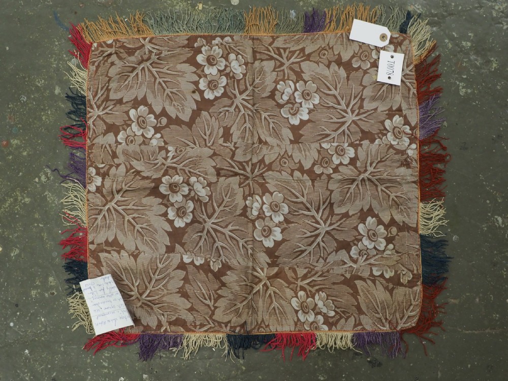 A square antique Uzbek Lakai embroidered textile featuring central circular and solar motifs in purple, red, and turquoise on a yellow fabric ground, finished with a multi-coloured fringed border. View VII