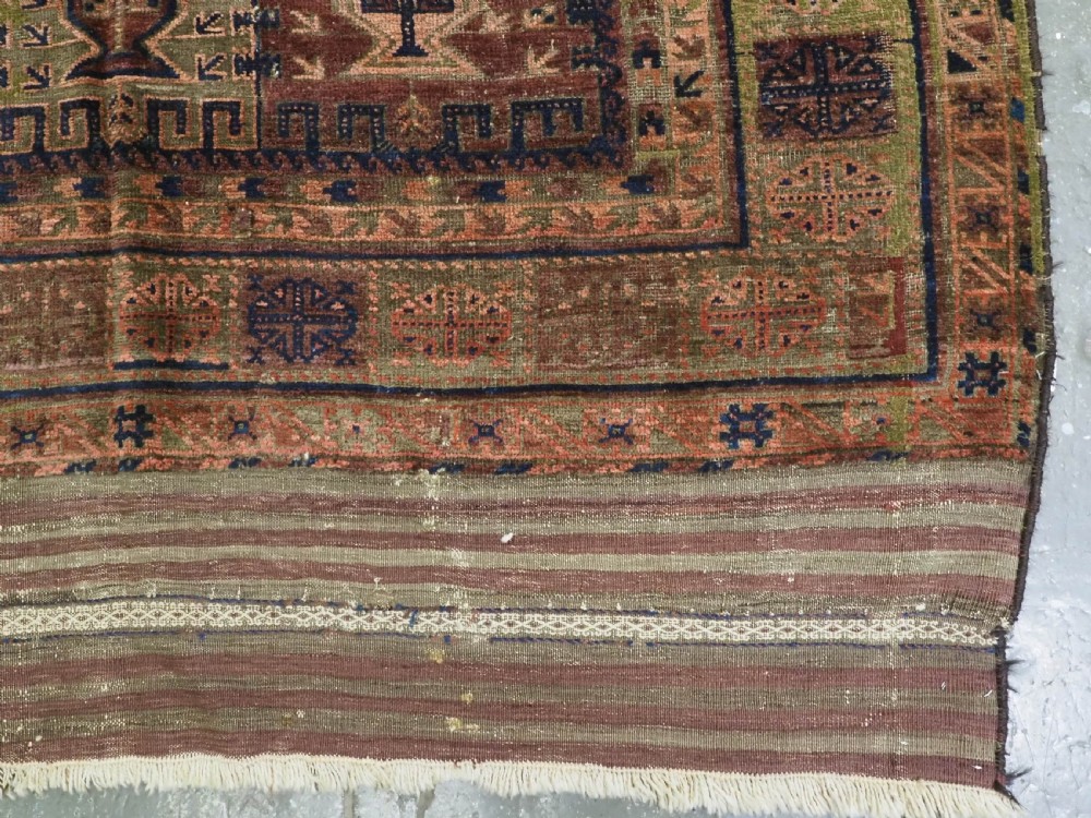 An antique hand-knotted Timuri Baluch wool carpet featuring geometric tree motifs in terracotta, indigo, and olive green hues with woven kilim borders. View XI