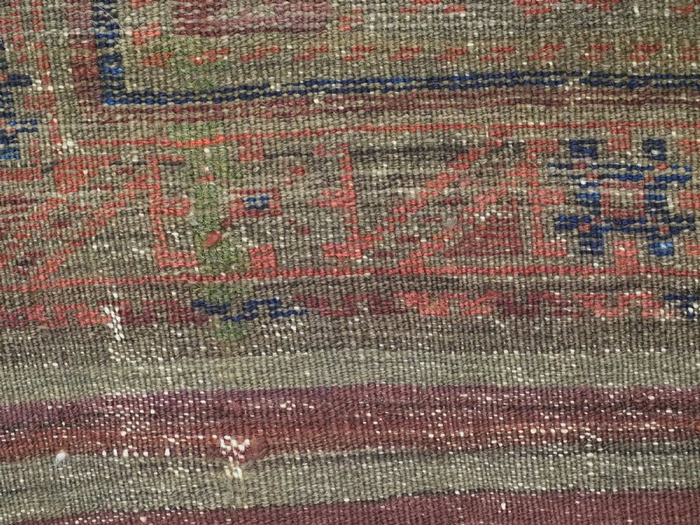 An antique hand-knotted Timuri Baluch wool carpet featuring geometric tree motifs in terracotta, indigo, and olive green hues with woven kilim borders. View XII